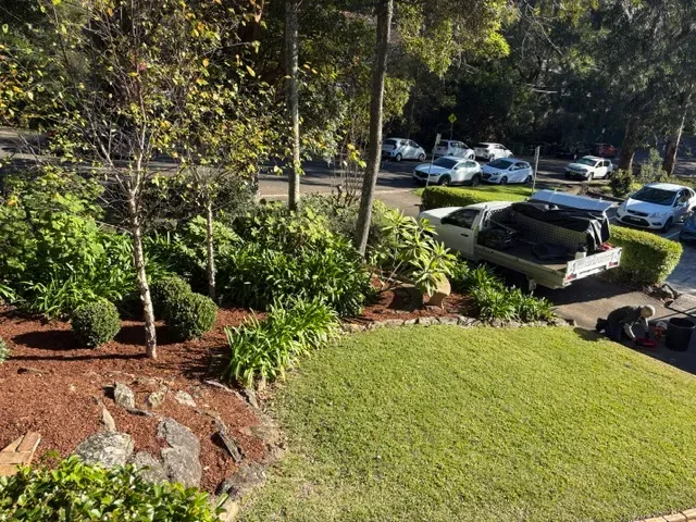 Mulched garden beds and mowed lawn with Mark's ute parked in the driveway